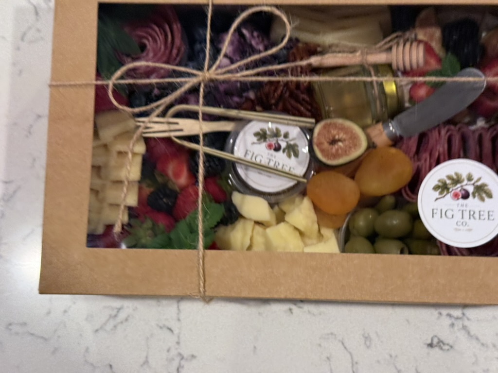 A ribbon-tied charcuterie presentation ready to give—or keep.